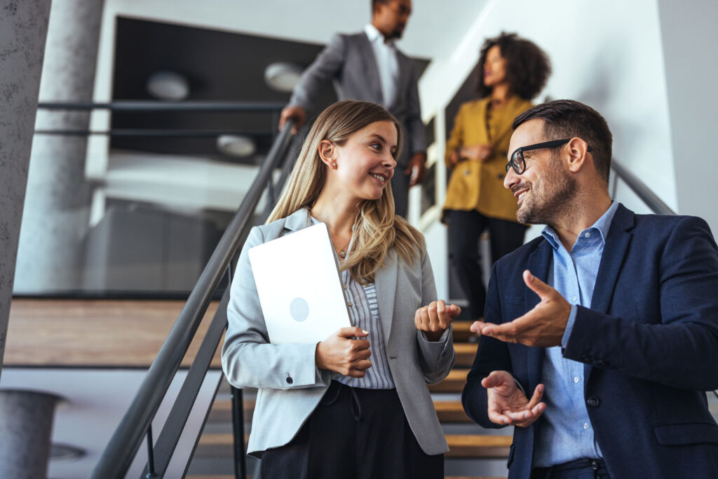 Colleagues chatting on staircase